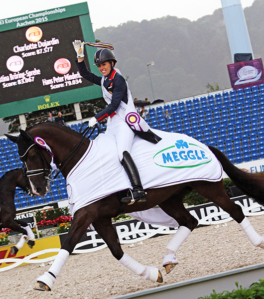 Charlotte Dujardin on Valegro holding aloft the gold medal won in the European Championship Grand Prix Special. © 2015 Ken Braddick/dressage-news.com 